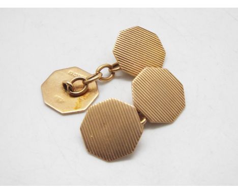 A pair of 9ct gold cufflinks of octagonal form with engine turned decoration, 5 grams.