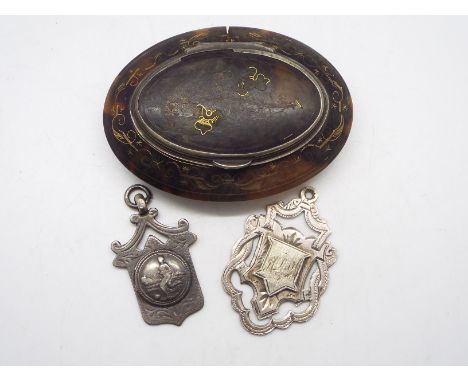 A Victorian tortoiseshell snuff box of oval form with white metal mounts and yellow metal inlay,  7 cm (l) and two silver spo