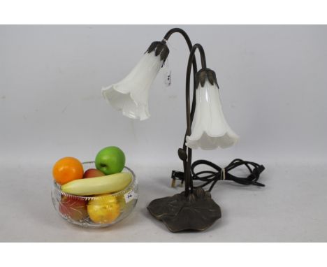 An Art Nouveau style, twin branch, table lamp, 42 cm (h) and a glass bowl containing faux fruit. [2]