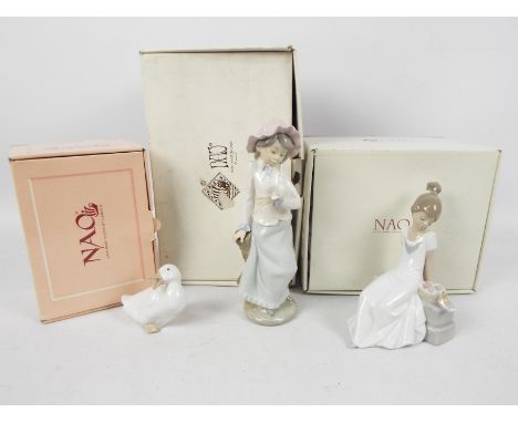 Three Nao figures, two contained in original boxes, the other in associated box, largest approximately 23 cm (h). [3]