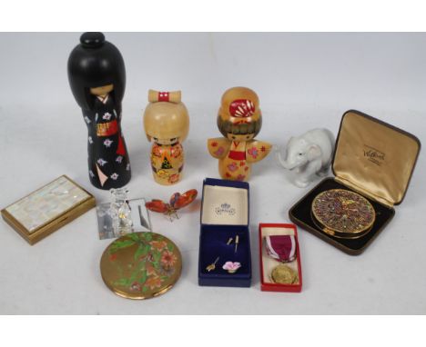 A mixed lot to include powder compacts, stick pins, small Lladro elephant (8 cm height), Swarovski, Japanese wooden models an