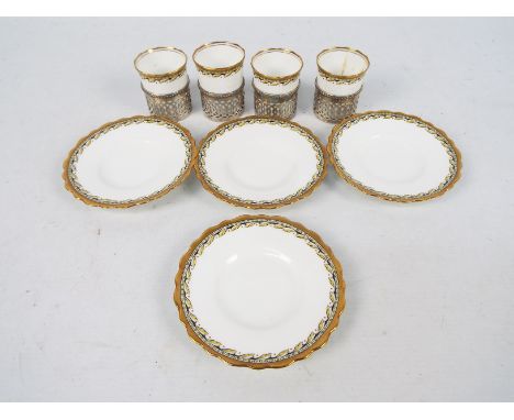 Four Aynsley coffee cans with pierced silver holders, Sheffield assay 1924, 101 grams / 3.2 ozt silver weight.