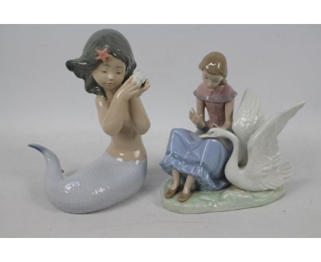 Nao - Two figures / groups comprising a mermaid holding a shell to her ear and a girl with swan, largest approximately 20 cm 