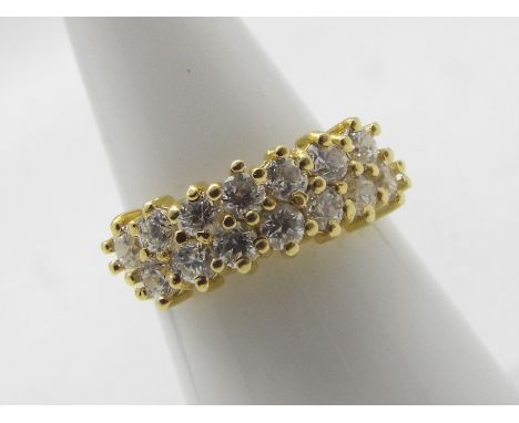 An 18ct yellow gold ring set with two rows of round brilliant cut white stones, size M+½, approximately 4.7 grams all in.