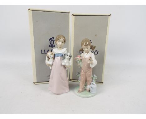 Lladro - Two boxed figures comprising # 5217 Spring and # 6419 Arms Full Of Love, largest approximately 19 cm (h). [2]