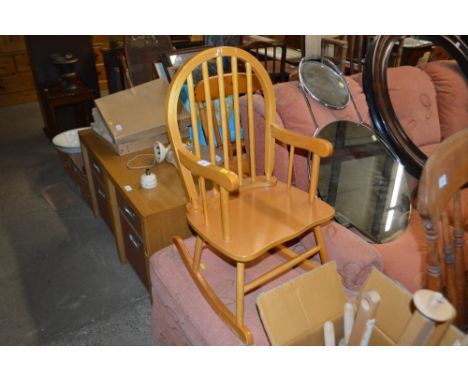 A children's stick back rocking chair