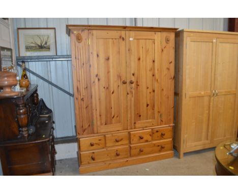 A modern pine double wardrobe fitted six drawers below