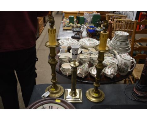 A pair of brass table lamp bases and a single brass table lamp