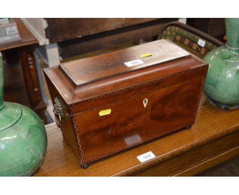 A mahogany and inlaid tea caddy