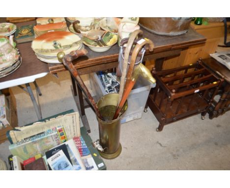 A brass stick stand and contents