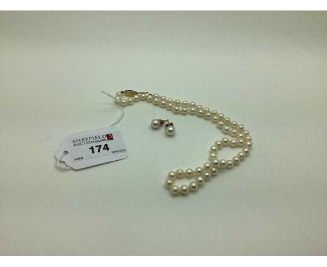 A Modern Single Strand Uniform Pearl Bead Necklace, knotted to clasp stamped "375"; together with pair of single pearl earstu