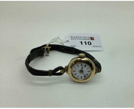 A Vintage 15ct Gold Cased Ladies Wristwatch, the white dial with black and red Arabic numerals (lacking glass), within plain 