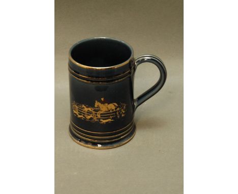 A Denby hunting tankard with blue ground body and hunting scene.  Height 13 cm. 