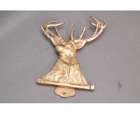 Brass door knocker in the form of a red stag.  Length 15 cm. 