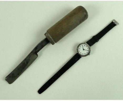 A lady's Art Deco wrist watch with silver case and black leather straps, the enamel dial with Arabic numerals and marked Swis