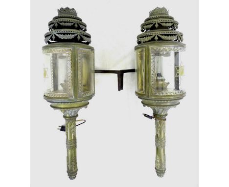 A fine pair of brass coach lamps, early 20th century, electrified, decorated with two tiers of floral swags over the engraved