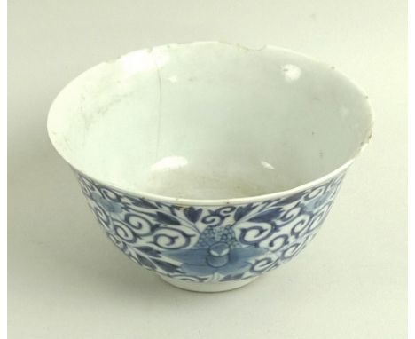 A Chinese porcelain tea bowl, Qing Dynasty, mid 18th century, decorated in underglaze blue with four orchids surrounded by sc