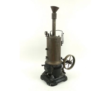 An early 20th century Marklin vertical steam engine, with fly wheel, gauge and levers, the bore of 25mm, and 20mm stroke, ove
