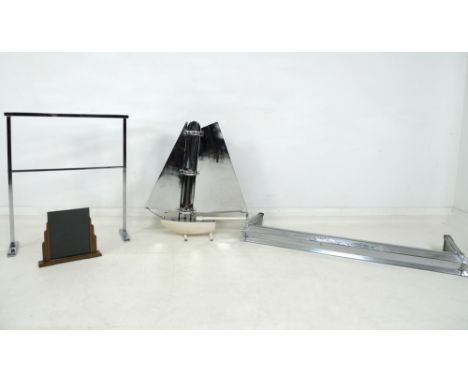 An Art Deco chrome plated fire surround, 125 by 36 by 11.5cm high, a similar towel rail, 63 by 20 by 78cm high, a novelty Art