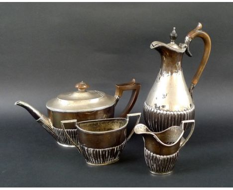 A Victorian harlequin four piece silver tea set, comprising teapot, hot water jug, creamer and sucrier, the lower bowls lobed