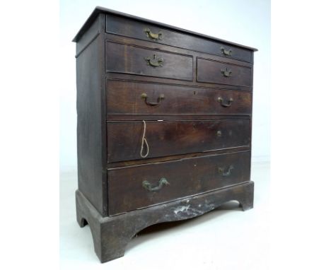 A Georgian elm chest of drawers, frieze glove drawer and two short over three long drawers, with cock beading and brass swan 