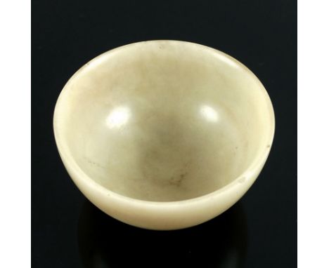 A late 19th / early 20th century Chinese or Japanese sake cup, likely formed of carved mutton fat jade, 6 by 3.4cm.