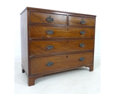 A George III mahogany chest of two short over three long graduating drawers, with cock beading and brass oval embossed plate 