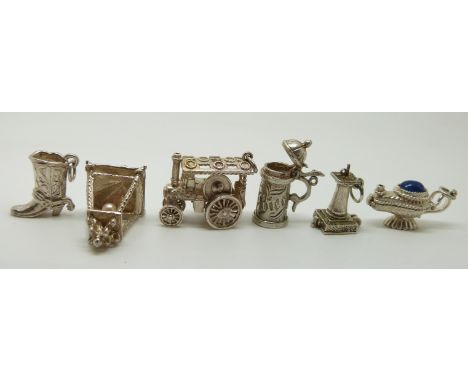 Six silver charms including a steam engine, sun dial, lamps,&nbsp; etc