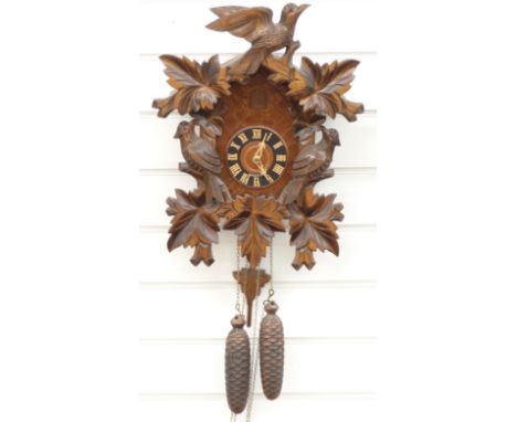 Black Forest German two train cuckoo clock with carved woodpecker decoration, 45cm tall&nbsp;