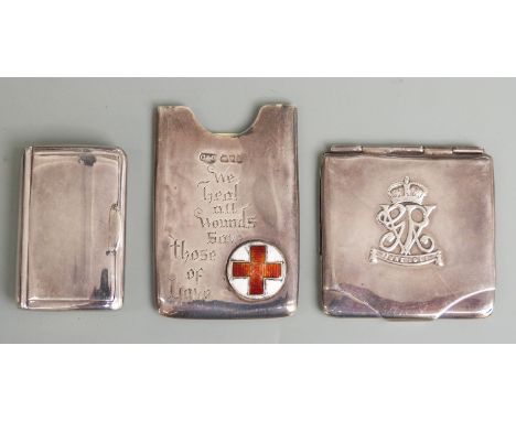 Three early 20th century hallmarked silver cases comrpising card slip case with enamel red cross and motto 'we heal all wound