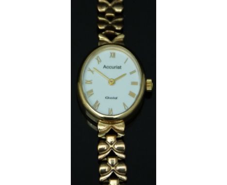 Accurist 9ct gold ladies wristwatch with gold hands and Roman numerals, white enamel dial and quartz movement, on 9ct gold br