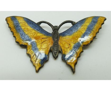 A silver brooch set with blue and yellow enamel in the form of a butterfly, 5 x 2.5cm