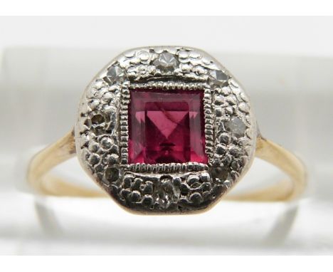 An 18ct gold ring set with a square cut ruby and diamonds in a platinum setting, 2.5g, size N