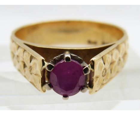 An 18ct gold ring set with an oval cut ruby, 4.8g, size M