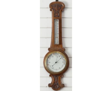 A carved oak aneroid barometer, 90cm tall