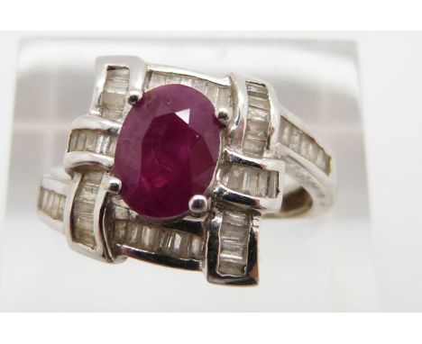 A 14k white gold ring set with a ruby and diamonds, total diamond weight approximately 0.32ct, 4.9g, size O