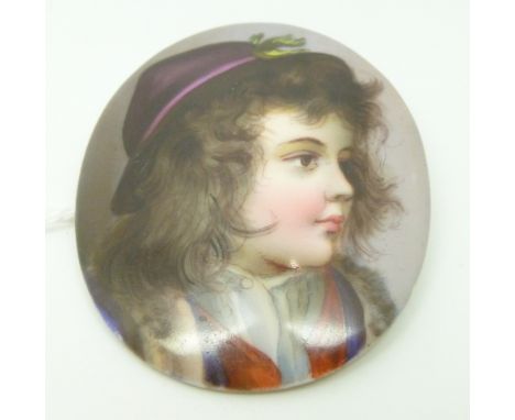 A porcelain brooch painted with a portrait miniature, 5 x 6cm