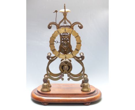 Brass single fusee skeleton clock, passing strike on a bell, raised on an oval mahogany plinth with bun feet, 50cm tall