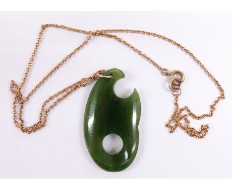 A nephrite jade pendant on 9ct gold chain, 4cm long