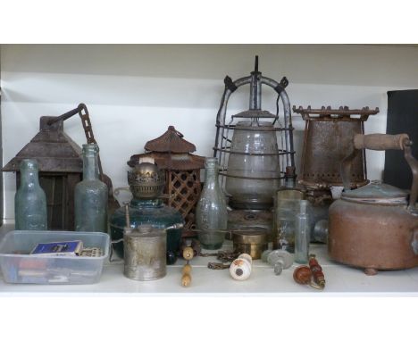 Quantity of oil lamps and heaters including one marked 1942, Worcester interest bottles G.H. Gray, Moreton-in-Marsh cistern p