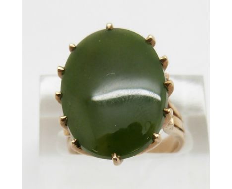 A 9ct gold ring set with a jade style plaque, size K