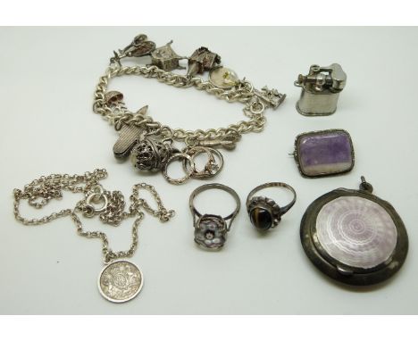 A silver brooch set with amethyst, silver charm bracelet, miniature lighter marked Pygmy Japan, and a silver compact/ pendant