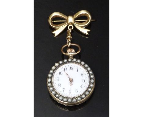 Silver gilt keyless winding open faced pocket watch on 9ct gold ribbon brooch with pearl set case, pierced gold hands, black 