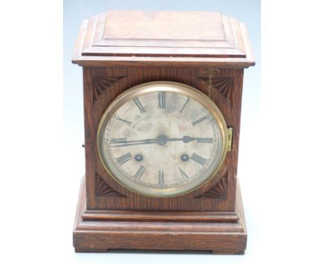 An oak cased two train mantel clock with silvered Roman dial, the two train movement striking on a gong, 25cm tall&nbsp;