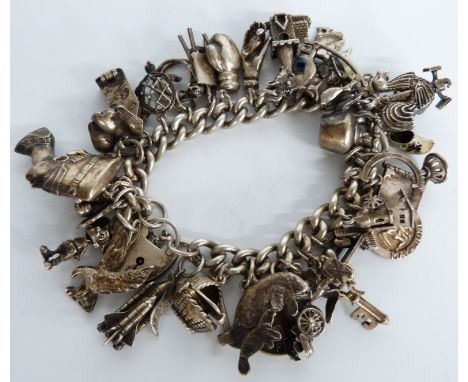 Silver charm bracelet including weather vane, space shuttle, cat, rocking horse and other charms