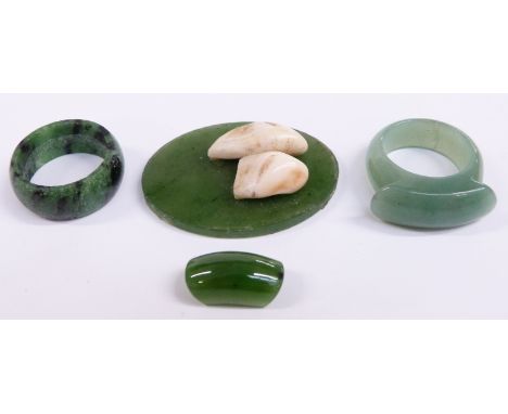 A nephrite jade plaque set with teeth and two jadeite rings&nbsp;