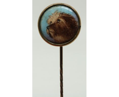 A stick pin with enamel dog finial