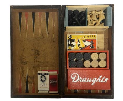 A vintage draughts / backgammon board disguised as a leatherbound book, containing boxed turned wooden chess and draughts pie