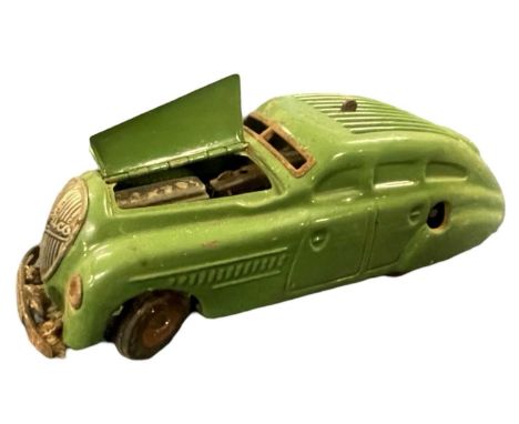 A 'Kommando Anno 2000' green Schuco clockwork aerodynamic car with lifting bonnet showing engine beneath, lacking key