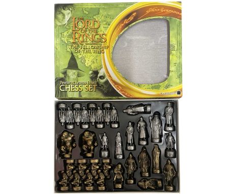A boxed Lord of the Rings: The Fellowship of the Rings pewter and bronze-effect finish chess set.